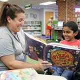 Greenbriar Elementary School Photo #5 - Ms. Slater delivers a slice of story time magic during independent reading time for kindergartners at the Greenbriar library!